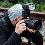 Canon EL-1 V2 Speedlite montado sobre cámara mirrorless en entorno profesional, flash activado