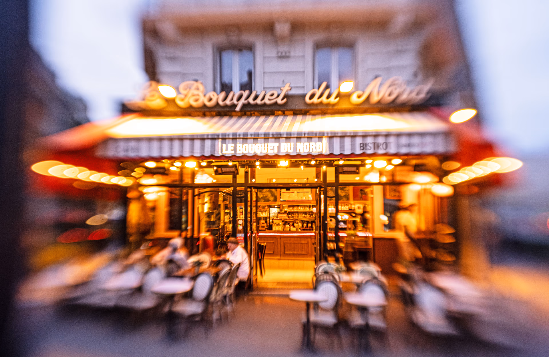 Café parisino concurrido en una esquina de la ciudad, escena de street photography en París