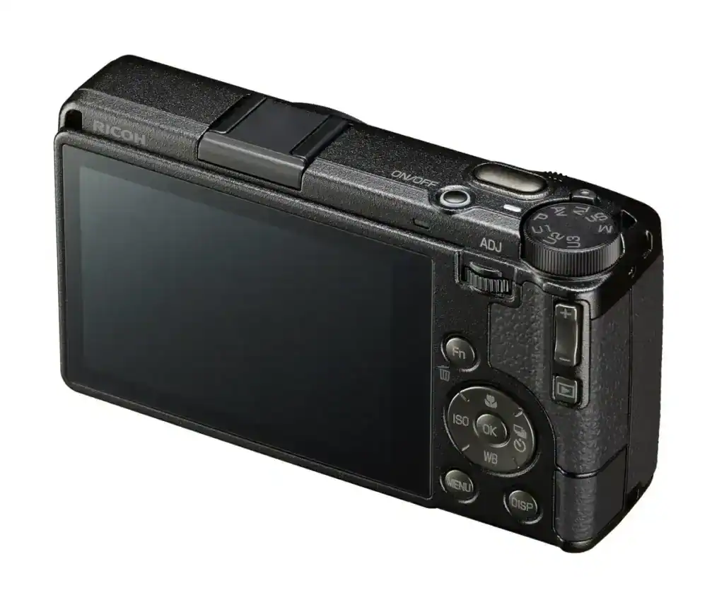 Cámara digital compacta negra con pantalla LCD y controles manuales